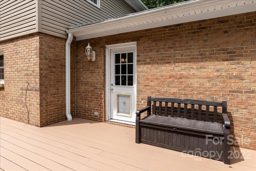 709 Neill Ridge Road Matthews, NC 28105 - Photo 31 of 38 a view of a patio with a table and chairs and wooden floor