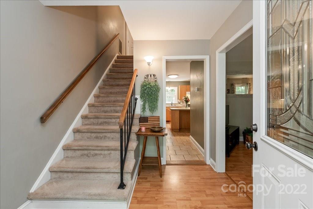 709 Neill Ridge Road Matthews, NC 28105 - Photo 7 of 38 a view of a hallway view with wooden floor and staircase