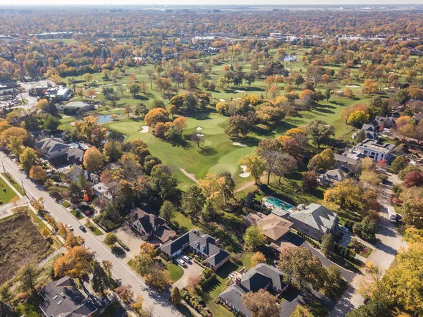 an aerial view of residential houses with city view