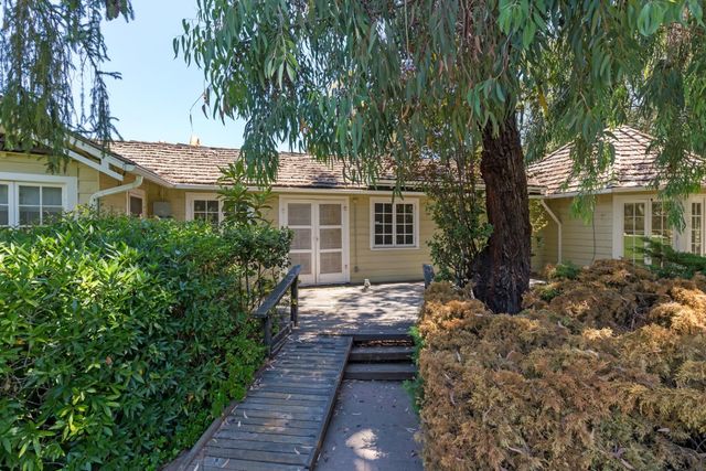 a front view of a house with a garden