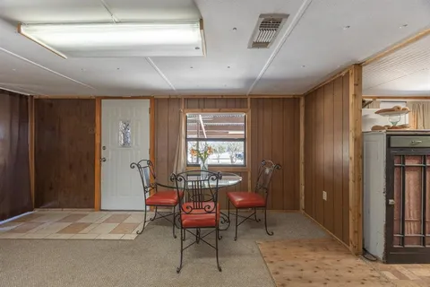 a living room with furniture chairs and a large window