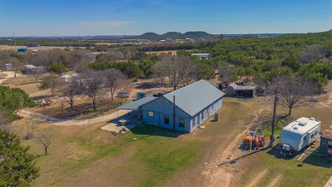 a view of a house with swimming pool and a yard