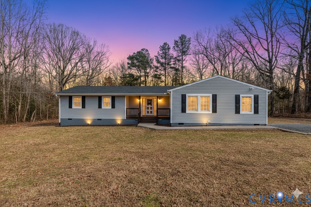 10298 Jamestown Road Ashland, VA 23005 - Photo 1 of 46 a front view of a house with a yard and garage