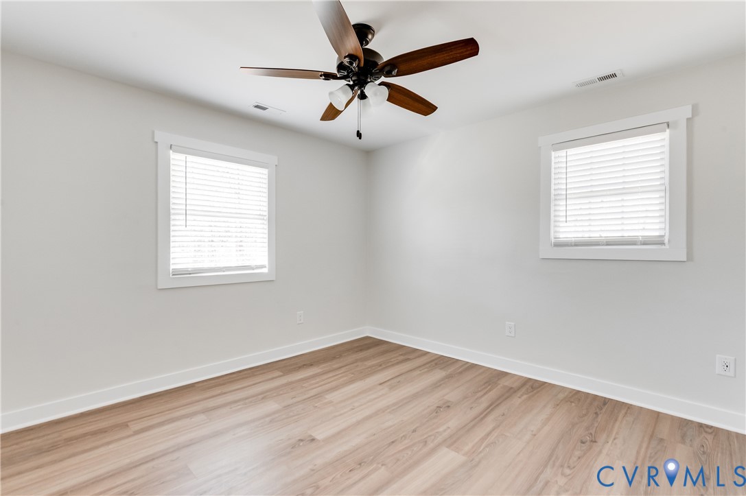 10298 Jamestown Road Ashland, VA 23005 - Photo 30 of 46 an empty room with wooden floor fan and windows