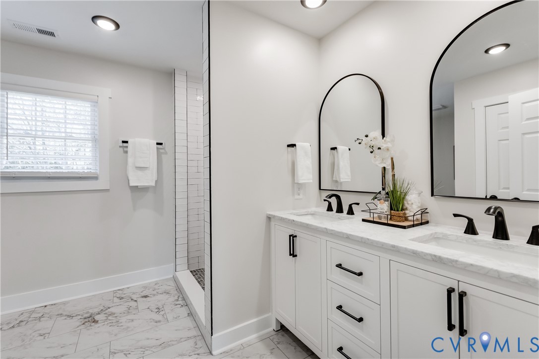 10298 Jamestown Road Ashland, VA 23005 - Photo 37 of 46 a bathroom with a double vanity sink and mirror