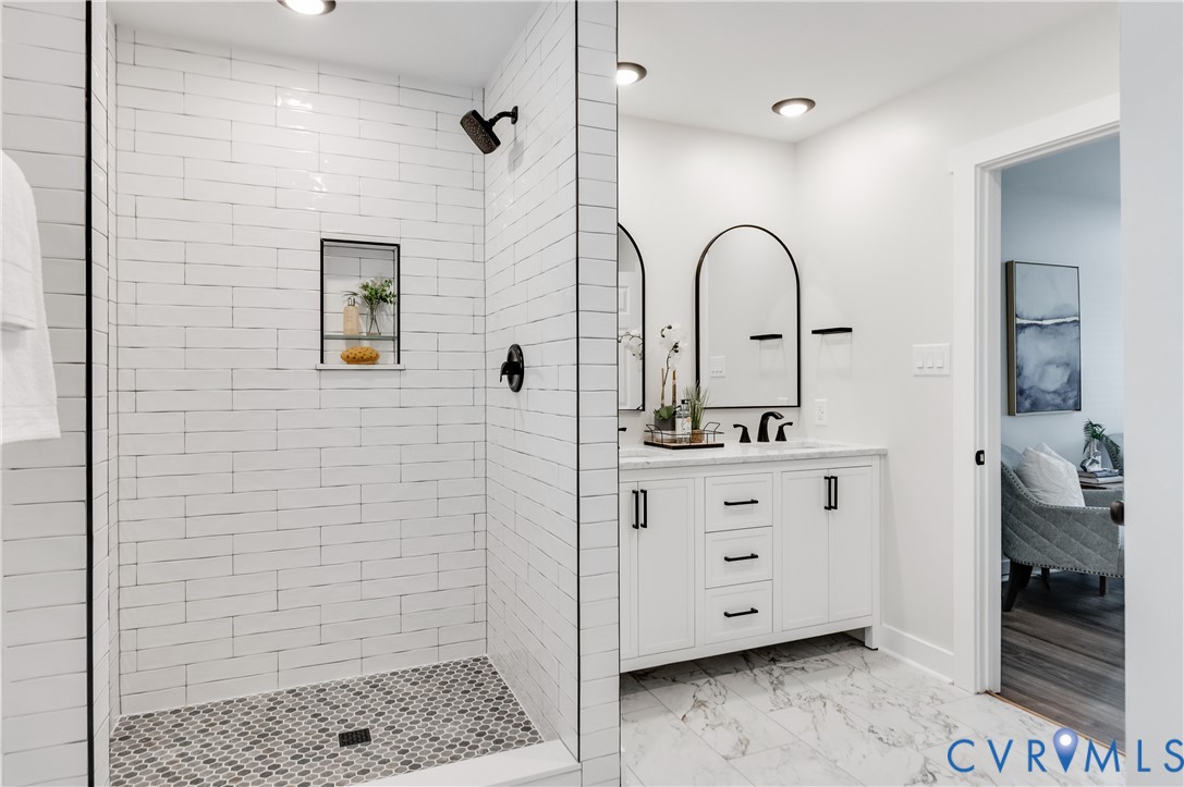 10298 Jamestown Road Ashland, VA 23005 - Photo 40 of 46 a bathroom with a sink a mirror and shower