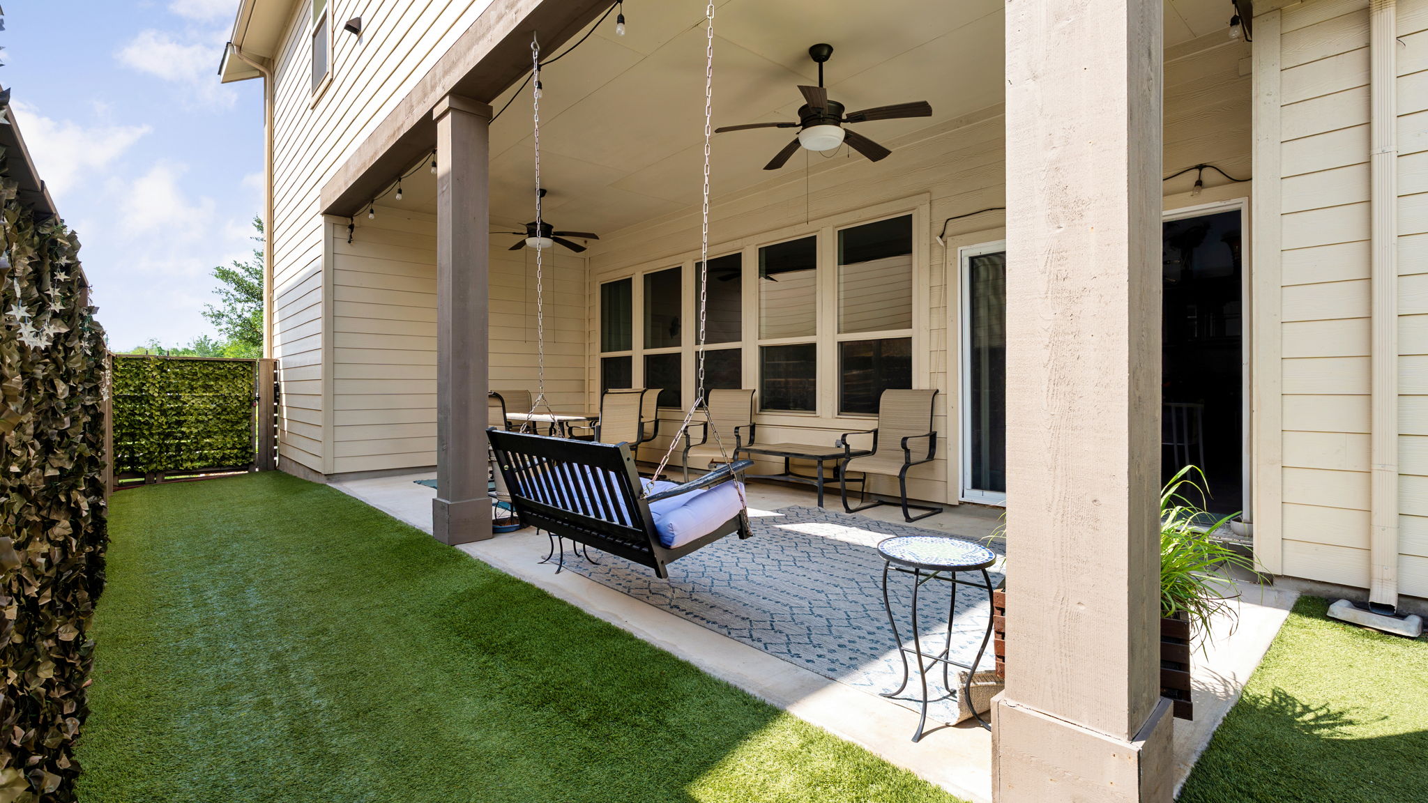 1511 Lawrence Street Austin, TX 78741 - Photo 10 of 26 Covered patio featuring a ceiling fan, outdoor string lighting, and a textured tile floor