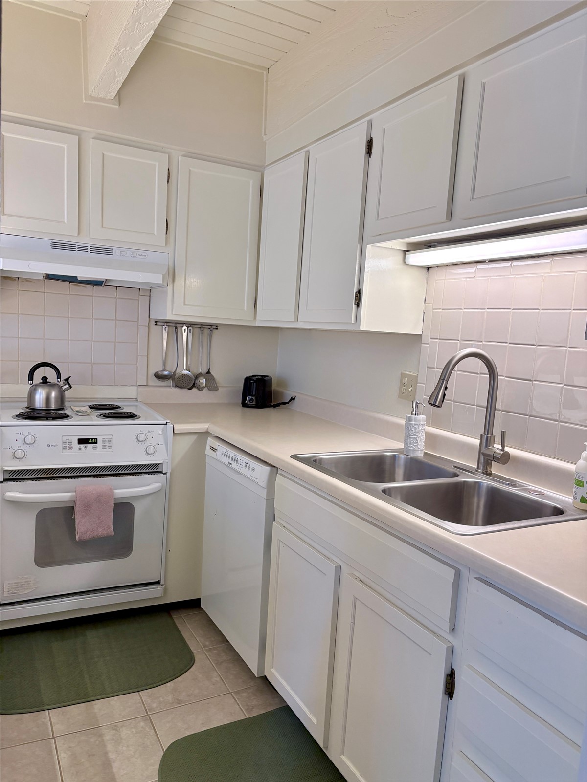 78 Guller Road, Unit 303 Copper Mountain, CO 80443 - Photo 13 of 43 a kitchen with white cabinets appliances and sink