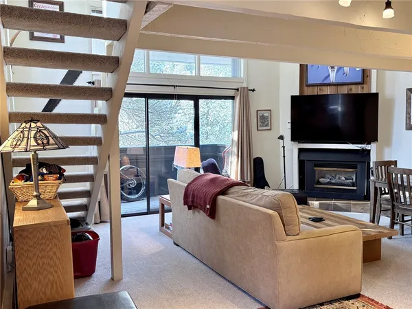 a living room with fireplace furniture and a flat screen tv