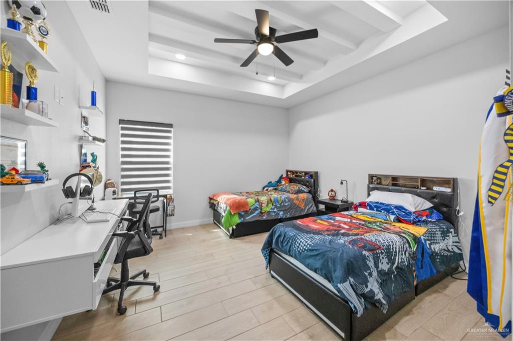 2800 Encke Rd Mission Mission, TX 78574 - Photo 18 of 21 a bedroom with two beds and a chandelier