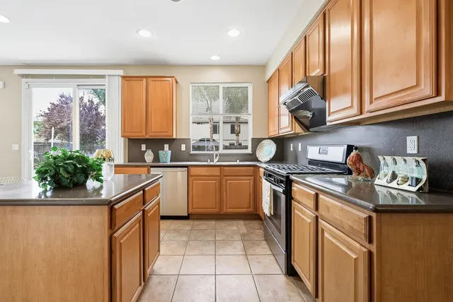 a view of an empty room with wooden floor and closet