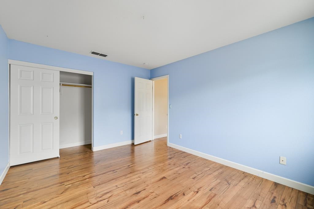 1413 Angus Street Patterson, CA 95363 - Photo 37 of 60 a view of an empty room with wooden floor and closet
