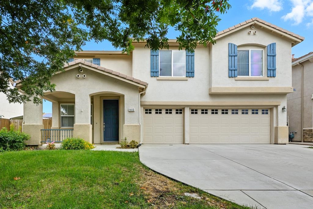1413 Angus Street Patterson, CA 95363 - Photo 40 of 60 a front view of a house with a yard and garage