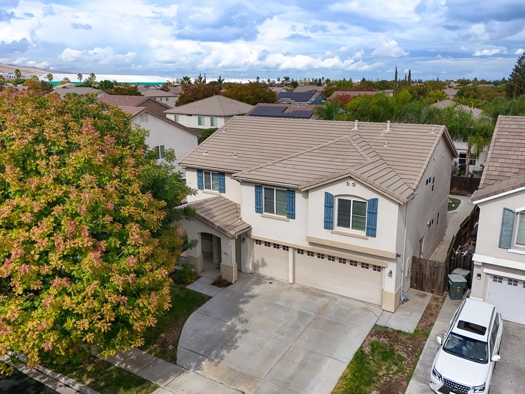 1413 Angus Street Patterson, CA 95363 - Photo 49 of 60 an aerial view of a house with a yard and lake view