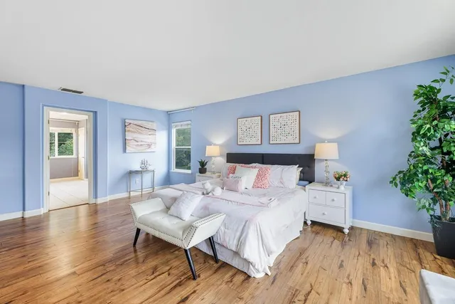 a bed room with bed and windows