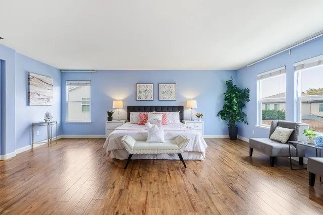 a bedroom with furniture and wooden floor