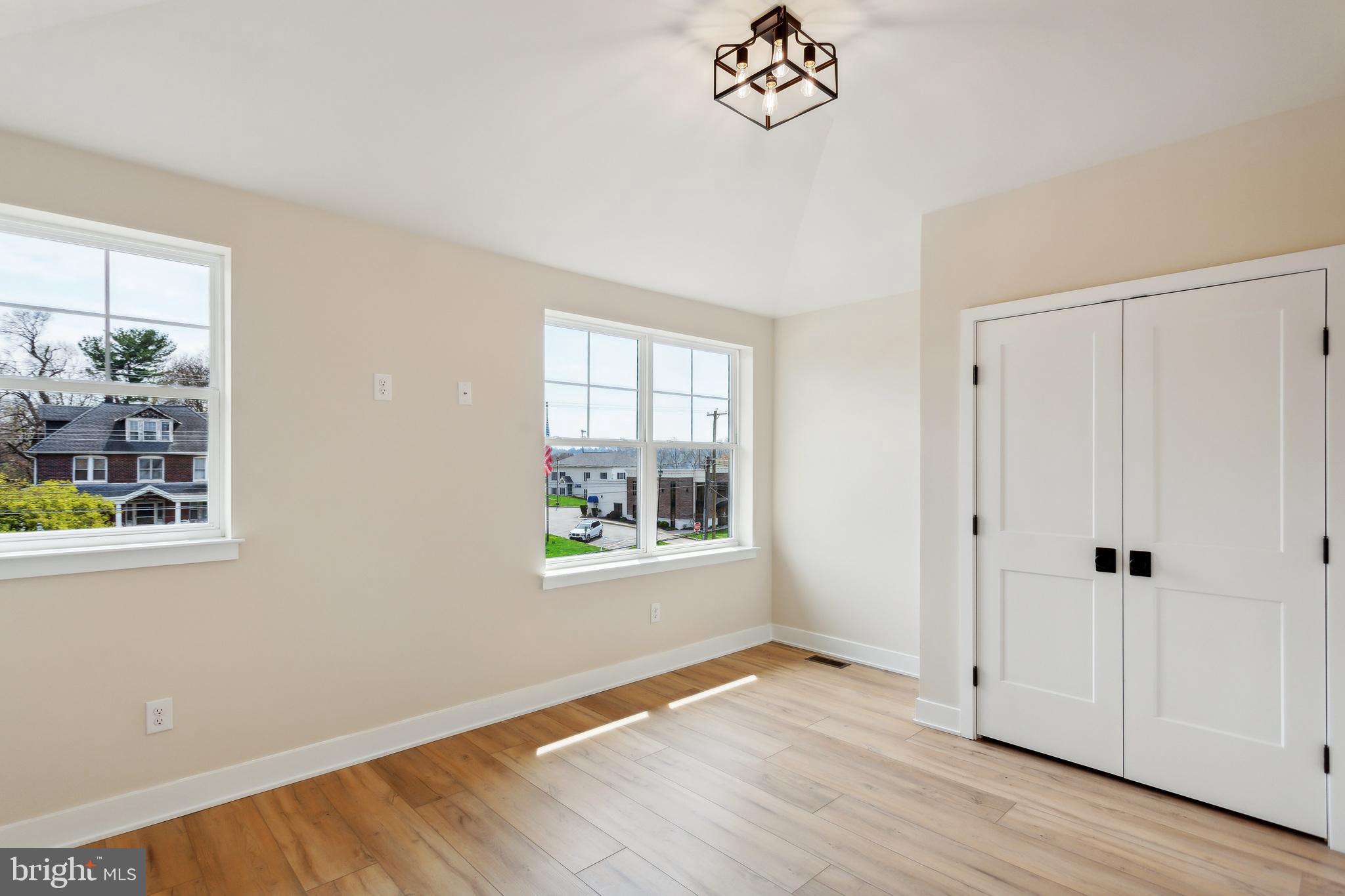1236 Butler Pike, Unit 2 Conshohocken, PA 19428 - Photo 2 of 15 an empty room with wooden floor and windows