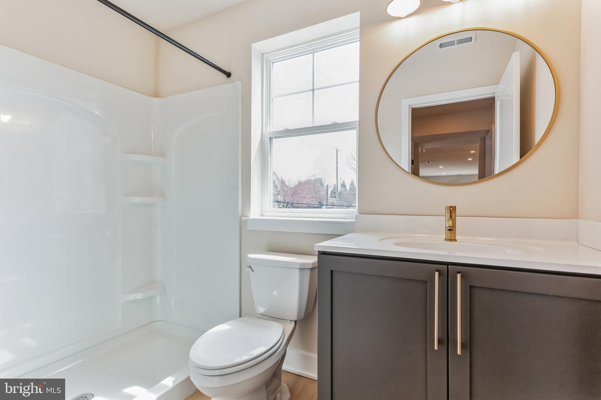 1236 Butler Pike, Unit 2 Conshohocken, PA 19428 - Photo 7 of 15 a bathroom with a toilet a sink and a mirror