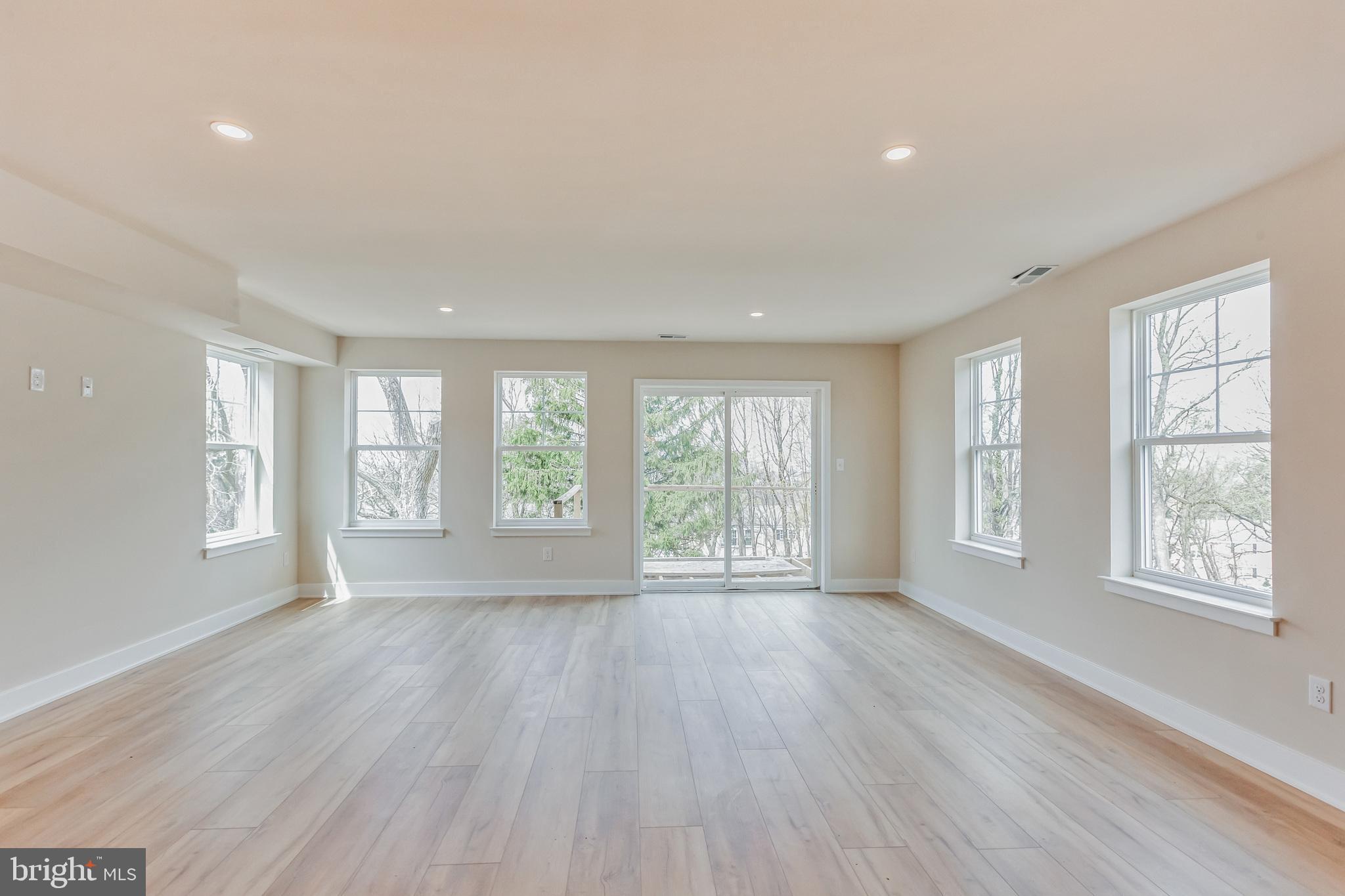 1236 Butler Pike, Unit 2 Conshohocken, PA 19428 - Photo 8 of 15 a view of an empty room with a window and wooden floor