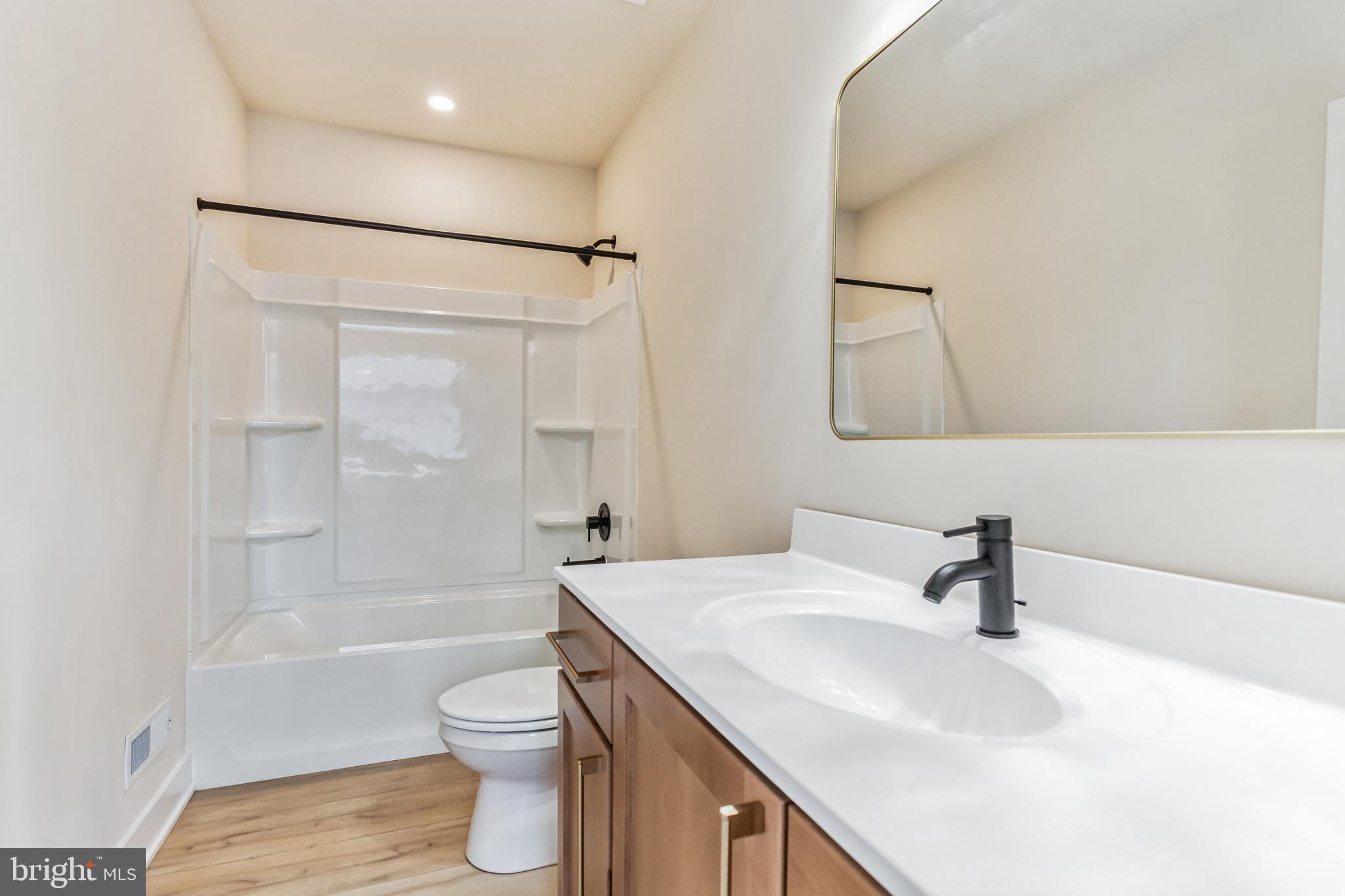 1236 Butler Pike, Unit 2 Conshohocken, PA 19428 - Photo 10 of 15 a bathroom with a sink a toilet and shower