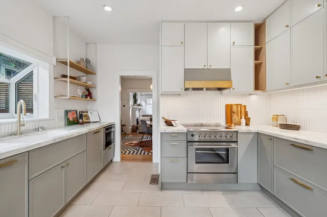 a kitchen with stainless steel appliances granite countertop a stove and a sink