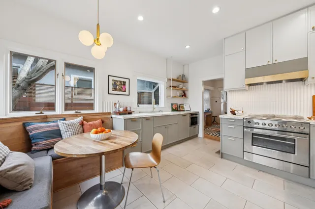 a kitchen with a table chairs and a stove