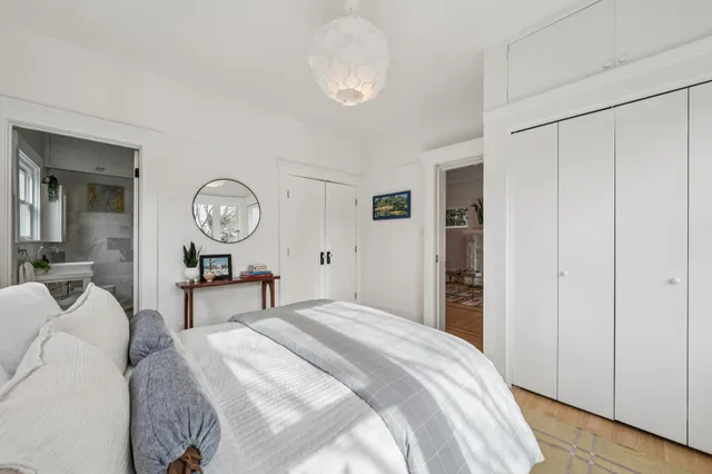 a bedroom with a bed and a chandelier