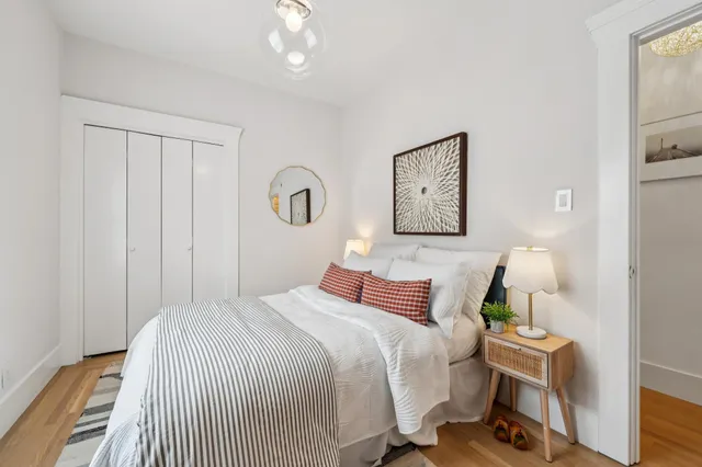 a bedroom with a bed and a chandelier