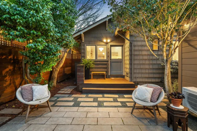 a backyard of a house with outdoor seating