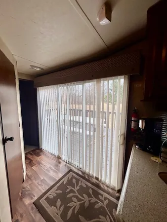 a view of an empty room and a window