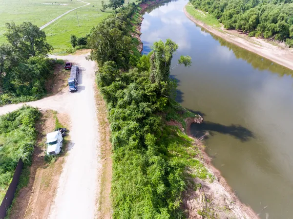 an aerial view of residential houses with outdoor space and trees