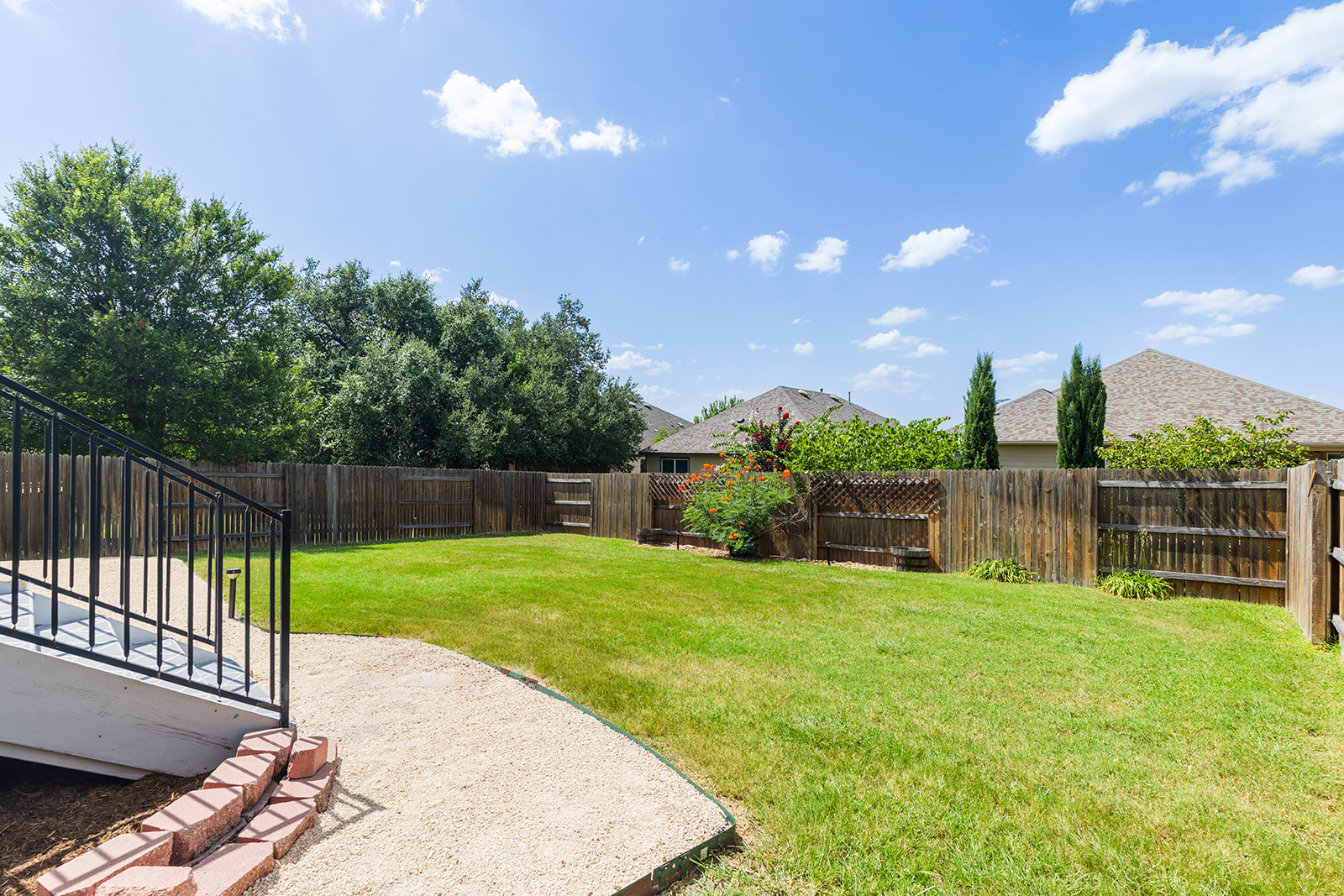 437 Sheepshank Drive Georgetown, TX 78633 - Photo 18 of 22 A spacious grass backyard with a wooden privacy fence, perfect for all sorts of activities or a place to install a pool or plant a garden complete with automatic irrigation.