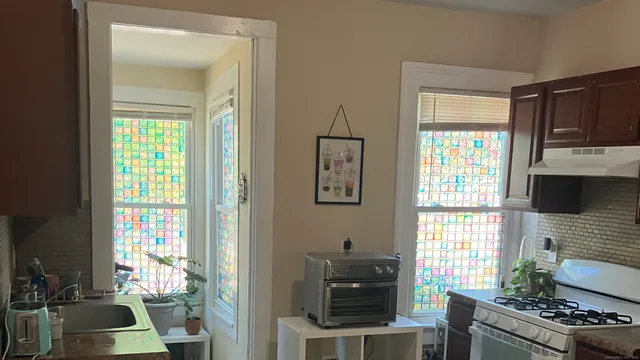 a view of a house with a window and brick walls