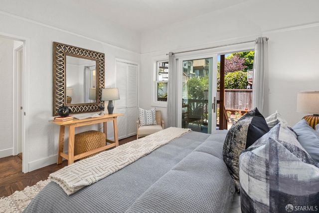 a bedroom with a bed a mirror and a window