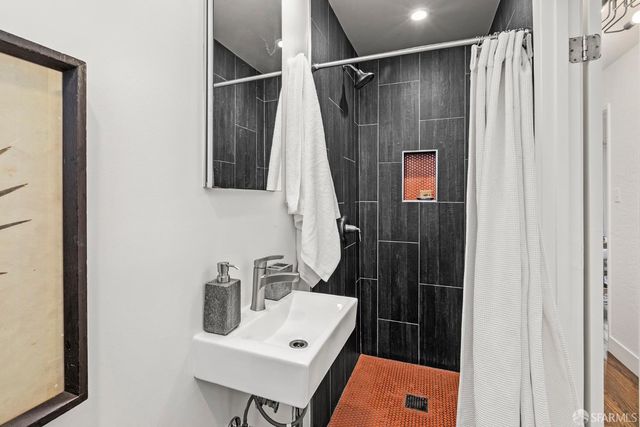 a bathroom with a sink toilet and shower