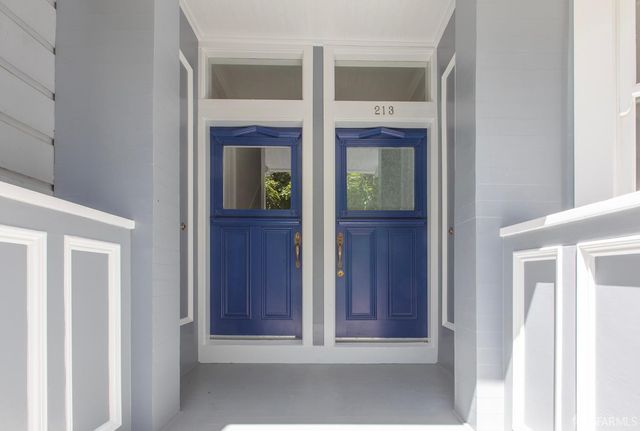 a view of a hallway with wooden door