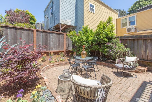 a view of a chairs and table in backyard