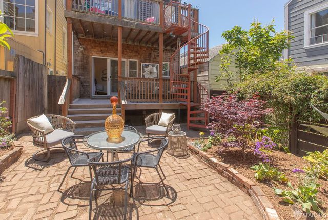 a view of a patio with table and chairs and potted plants
