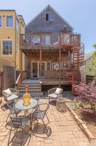 a view of a patio with a table and chairs