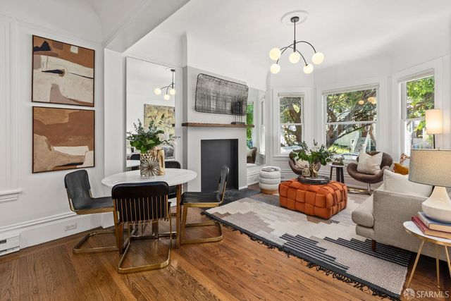 a living room with furniture fireplace and window