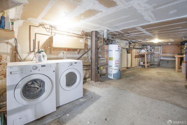 a view of a storage & utility room with two washing machine