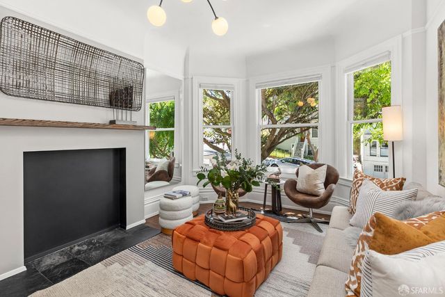 a living room with furniture potted plant and a fireplace