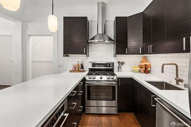 a kitchen with stainless steel appliances a sink stove and refrigerator