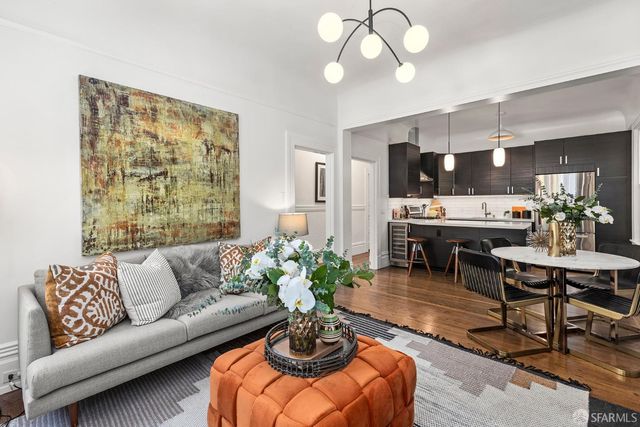 a living room with furniture potted plant and a window