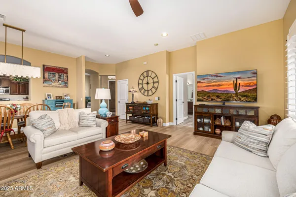a living room with furniture and a potted plant