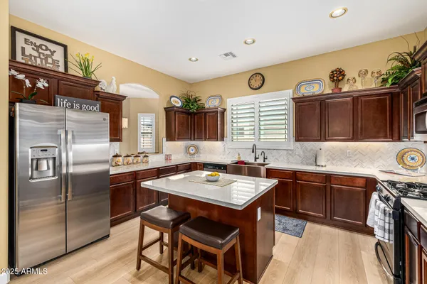 a kitchen with stainless steel appliances a sink stove and refrigerator
