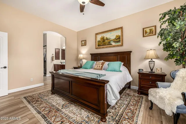 a bedroom with a bed and a mirror on dresser