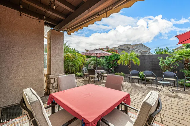 a view of a patio with a table and chairs
