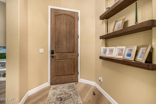 a living room with furniture a flat screen tv and a large window