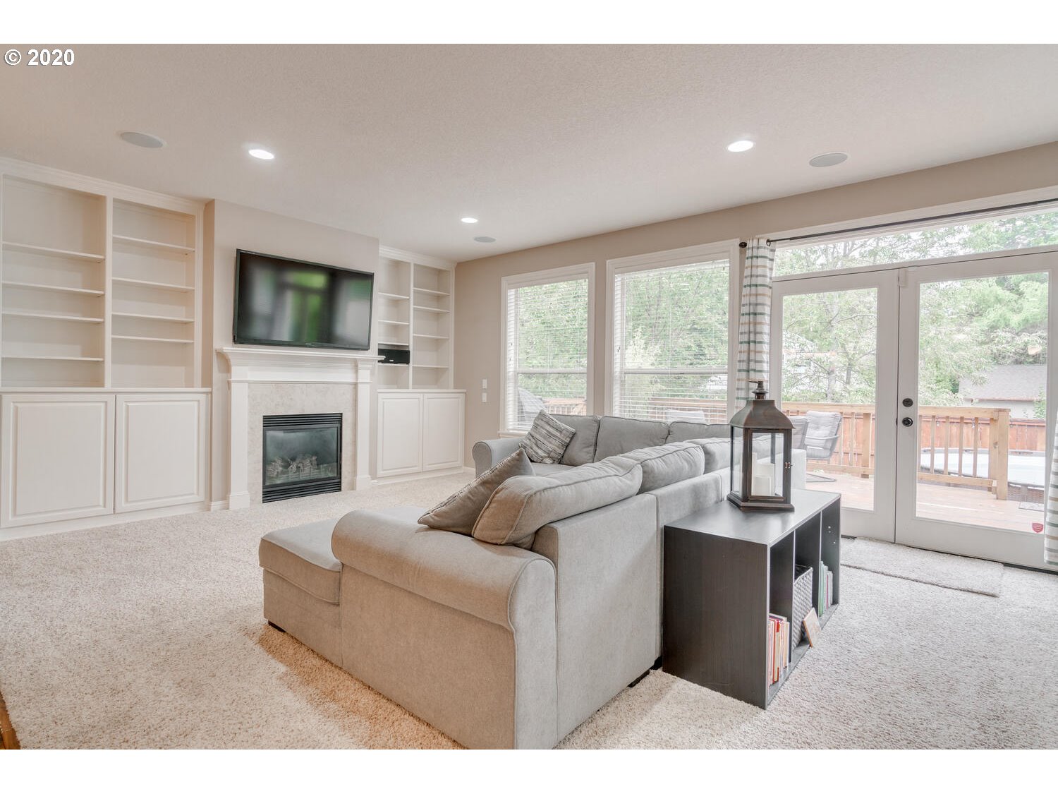 9245 Southwest Rambler Lane Portland, OR 97223 - Photo 5 of 19 a living room with fireplace furniture and a flat screen tv
